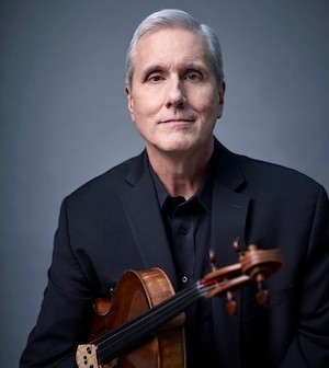Lawrence Dutton holding a viola