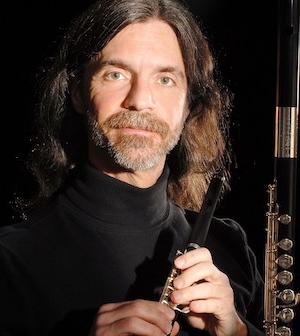 Kelly Via holding a piccolo and next to a flute