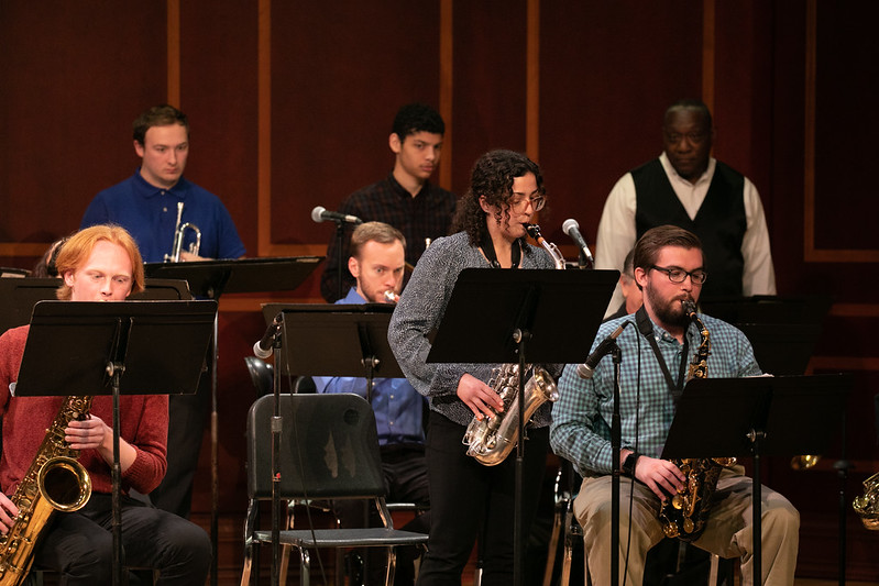 Mercer Jazz Ensemble on stage, with a female saxophonist standing for a solo