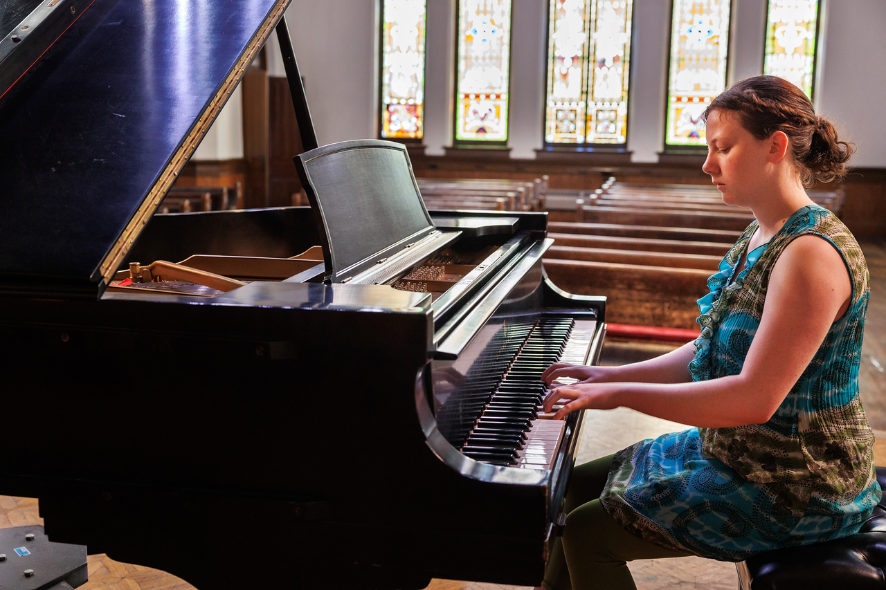 A pianist plays in a church