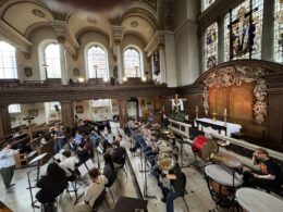 students in Wind Ensemble seated at rehearsal for performance in London