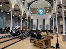 A side view of the wind ensemble students performing in Manchester