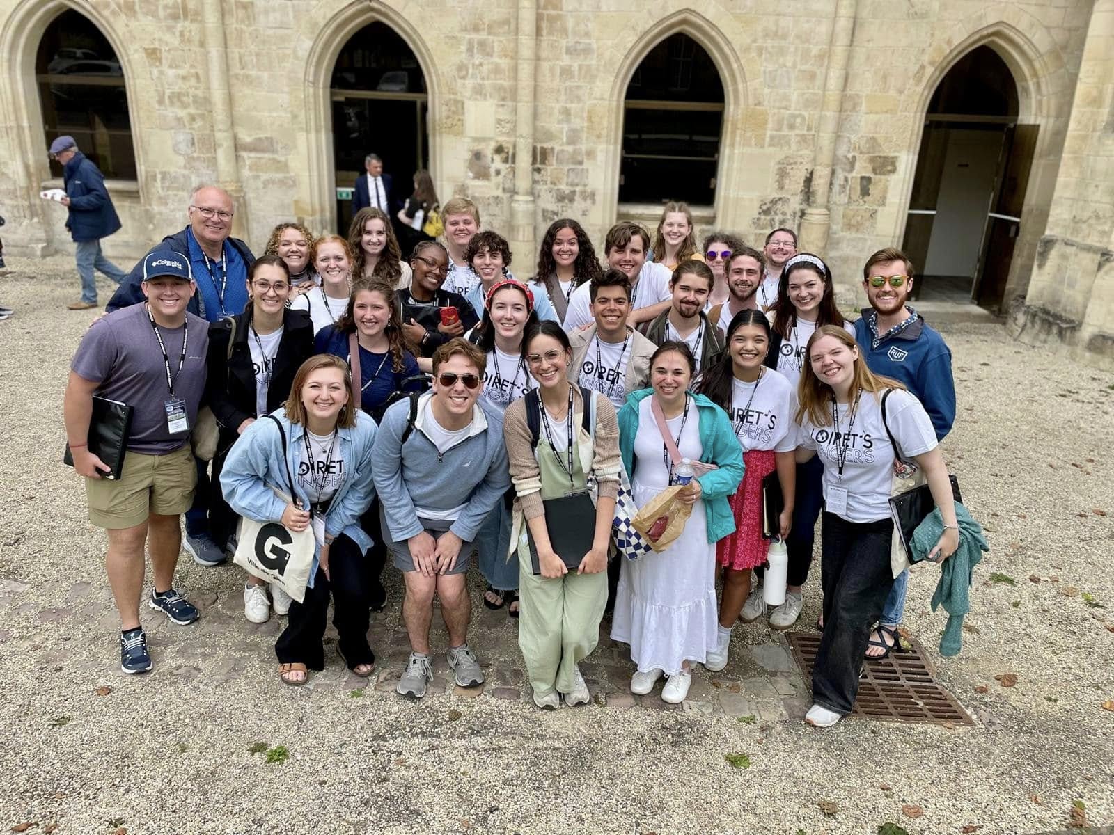 Students posing in front of a French building