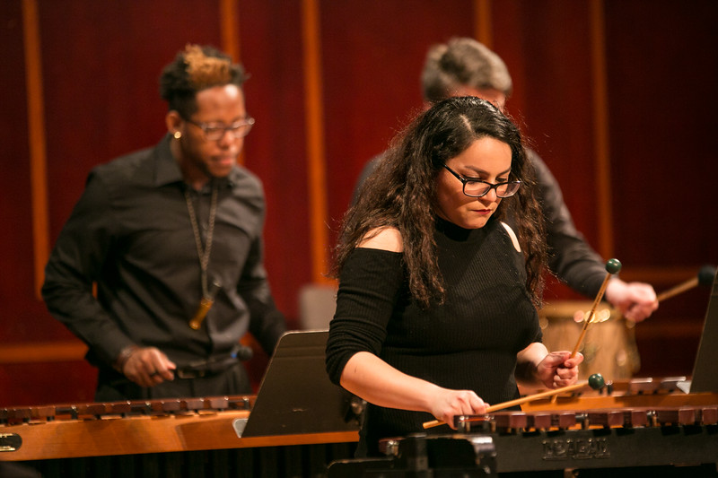 3 students playing marimbas on stage