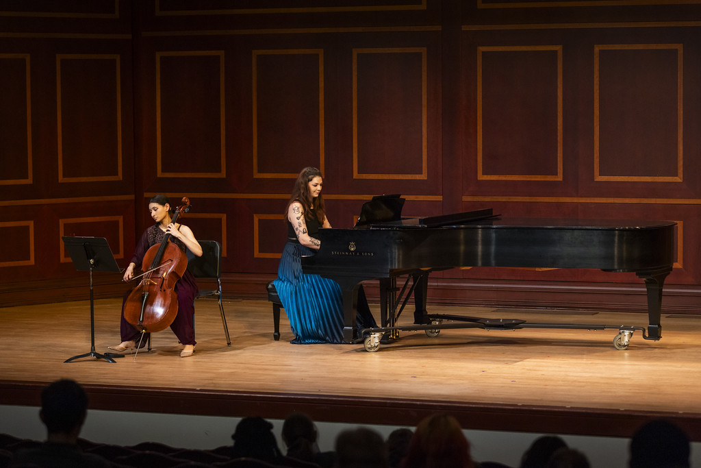 pianist at steinway grand piano, cellist seated in front