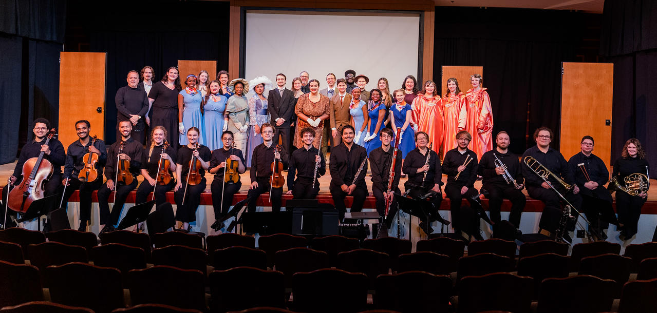 the cast and orchestra pose for a photo after the show