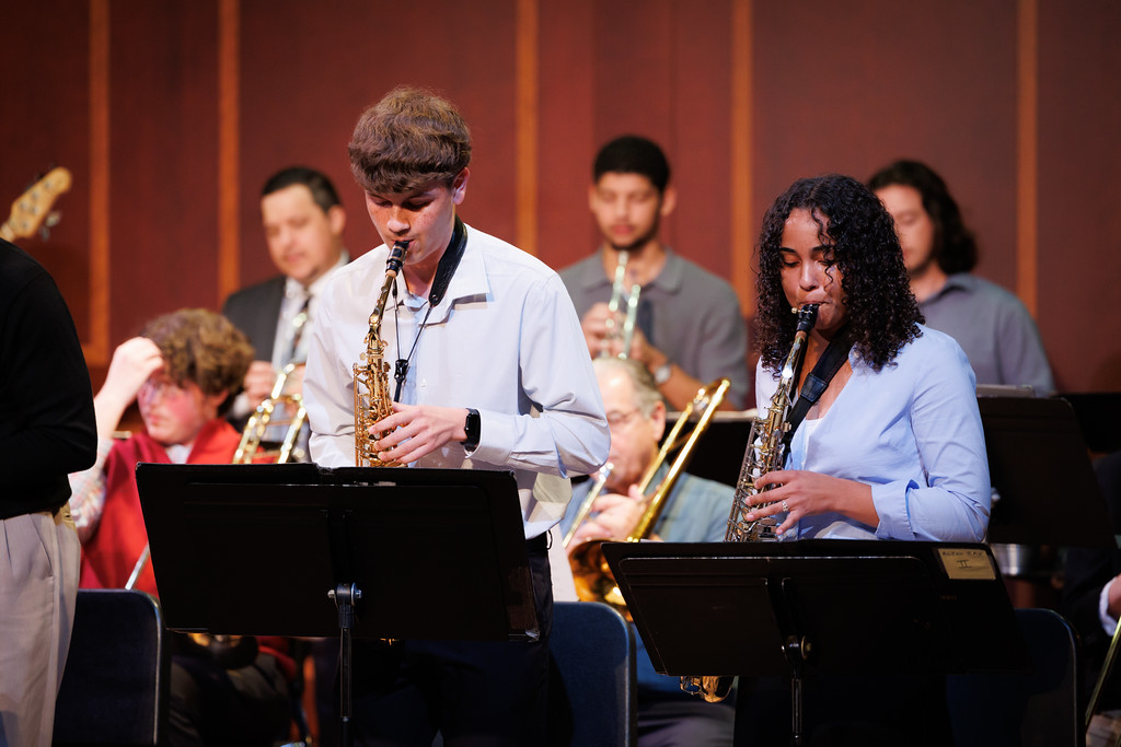 Two saxophonists on stage with the Jazz Ensemble