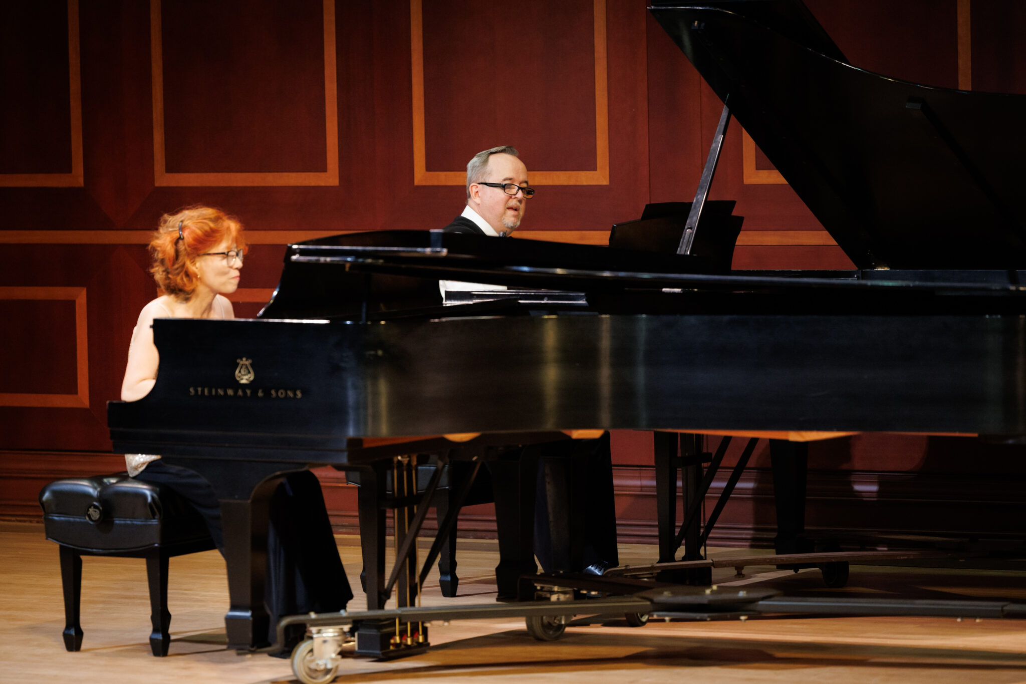 Dr. Kyung-A Yoo and Dr. R. Timothy McReynolds perform on two grand pianos
